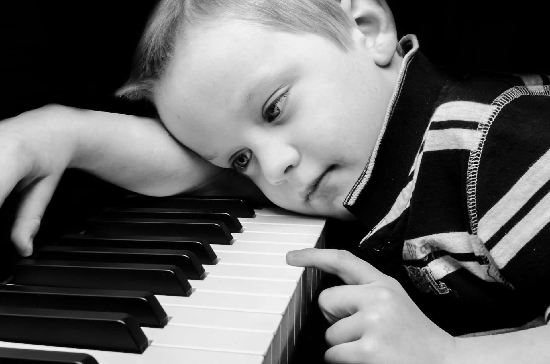 sad-boy-plays-piano