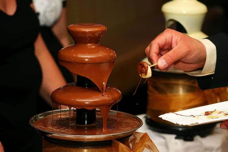 person-standing-in-front-of-chocolate-fountain