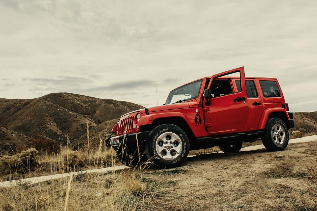 photo-of-red-suv-on-dirt-road-1592261