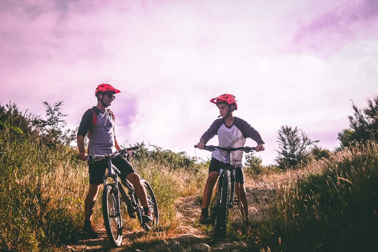 two-man-riding-mountain-bike-on-dirt-road-at-daytime-1010557