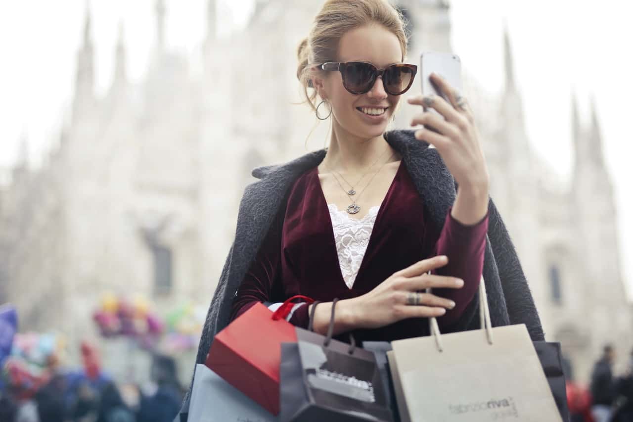 woman-in-maroon-long-sleeved-top-holding-smartphone-with-972884