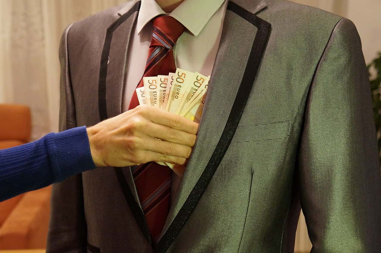 6_-_man_in_suit_holding_with_woman's_hand_reaching_to_take_50_euro_banknotes_-_royalty_free,_without_copyright,_public_domain_photo_image