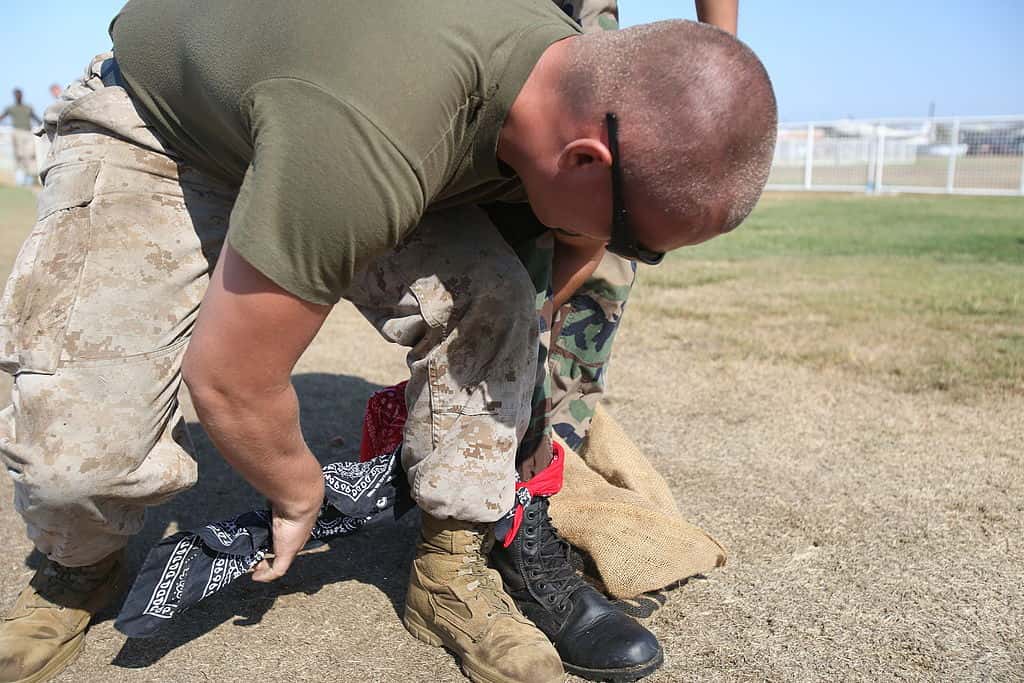 Lance_Cpl._Robert_Buck,_a_volunteer_with_the_Single_Marine_Program,_ties_his_leg_to_his_Young_Marine