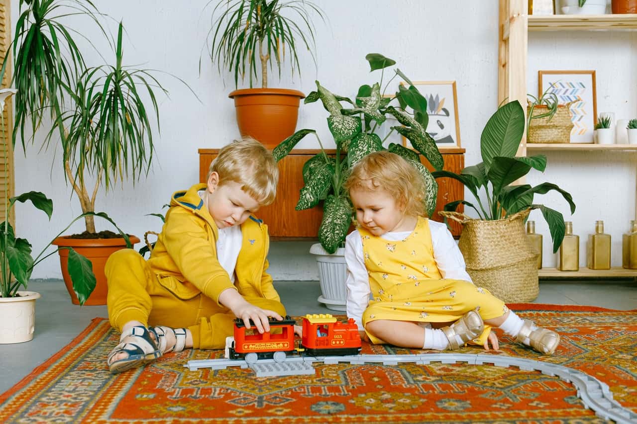 adorable-little-boy-and-girl-playing-with-toy-train-3771505