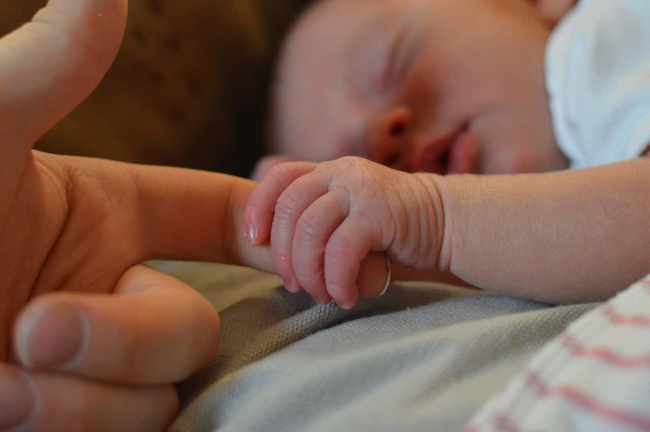 baby-holding-human-finger-225744
