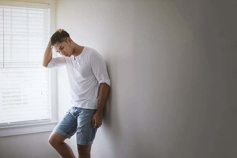 black-hair-man-wearing-white-henley-s-shirt-and-denim-short
