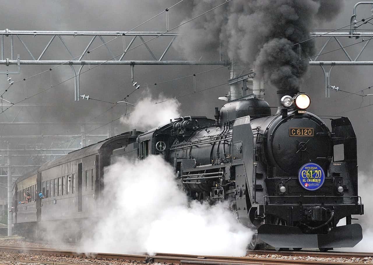 black-train-on-rail-and-showing-smoke-72594