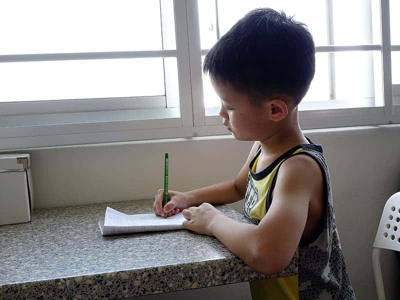 boy-writing-on-notebook