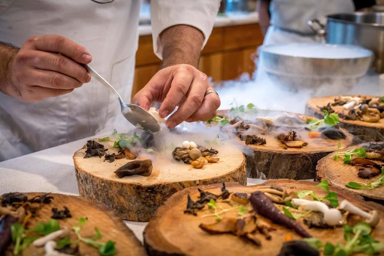 chef-preparing-vegetable-dish-on-tree-slab-1267320