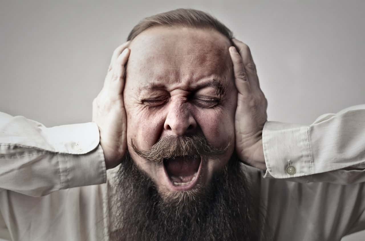 close-up-photo-of-screaming-man-with-a-full-beard-covering-3764535
