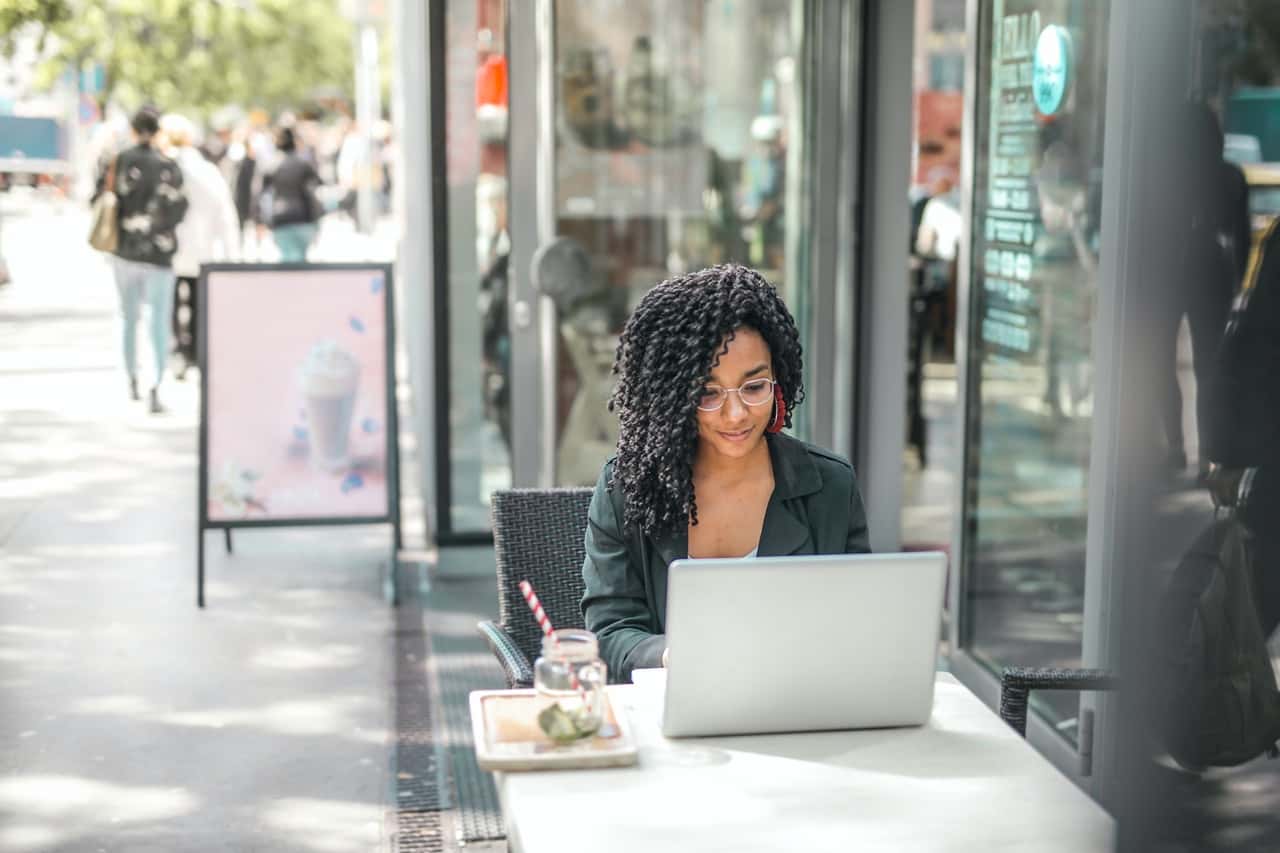ethnic-young-woman-using-laptop-while-having-tasty-beverage-3768894
