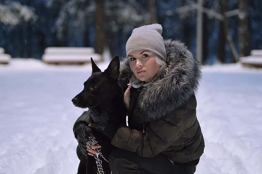 girl-with-dog-black-shepherd-mongrel-blonde-woman-with-dog-in-winter-forest-winter-forest-snow
