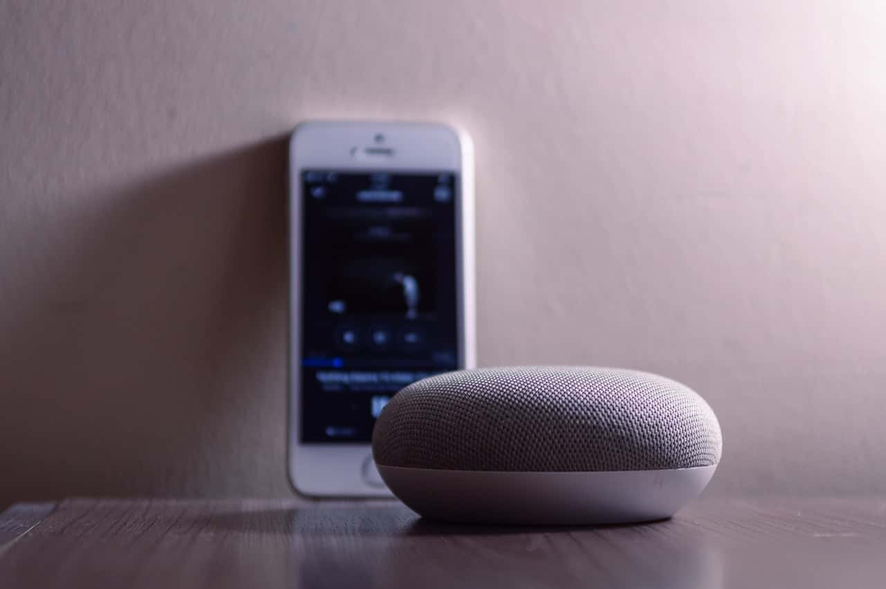 gray-google-home-mini-beside-silver-iphone-5s-1279365