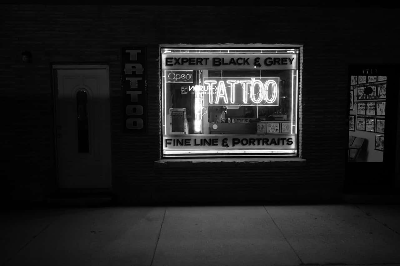 grayscale-photo-of-tattoo-neon-signage-2087995