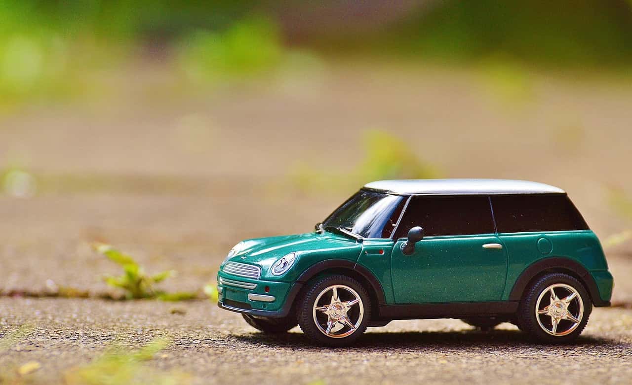 green-scale-model-car-on-brown-pavement-35967