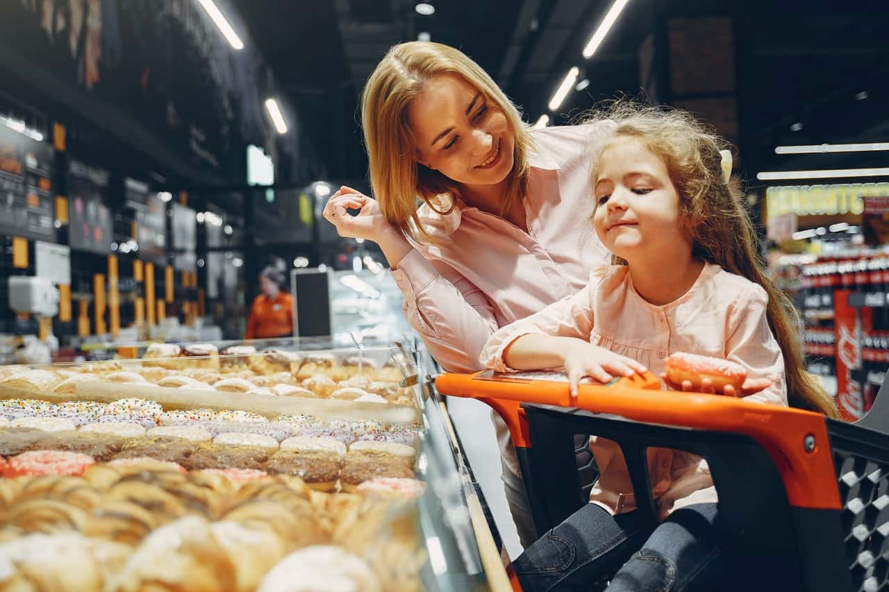 little-girl-sitting-on-shopping-cart-3985080