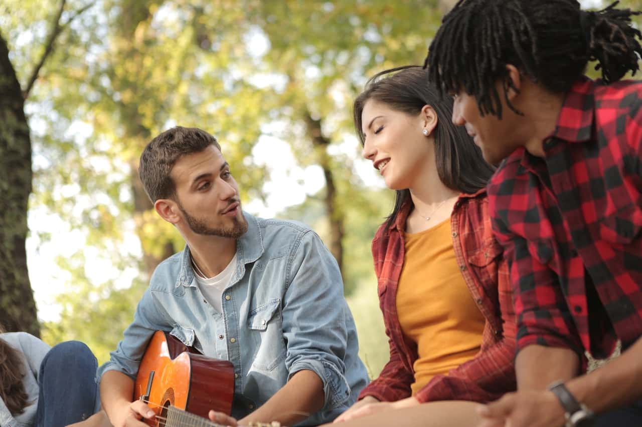 male-with-guitar-singing-with-friends-3777732
