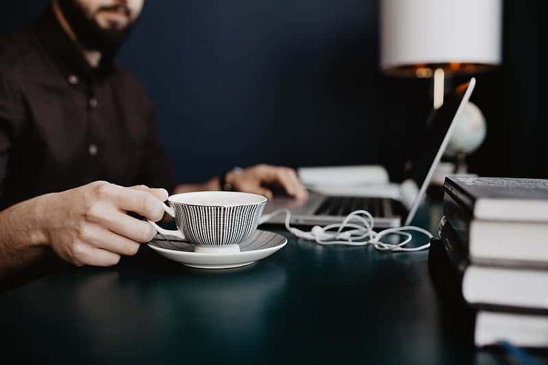 male-working-with-a-laptop-and-a-cup-of-coffee