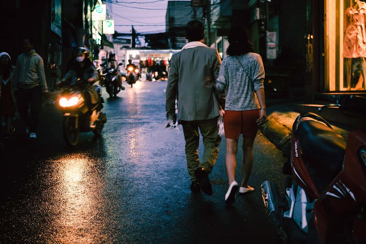 man-and-woman-walking-on-street-1624376