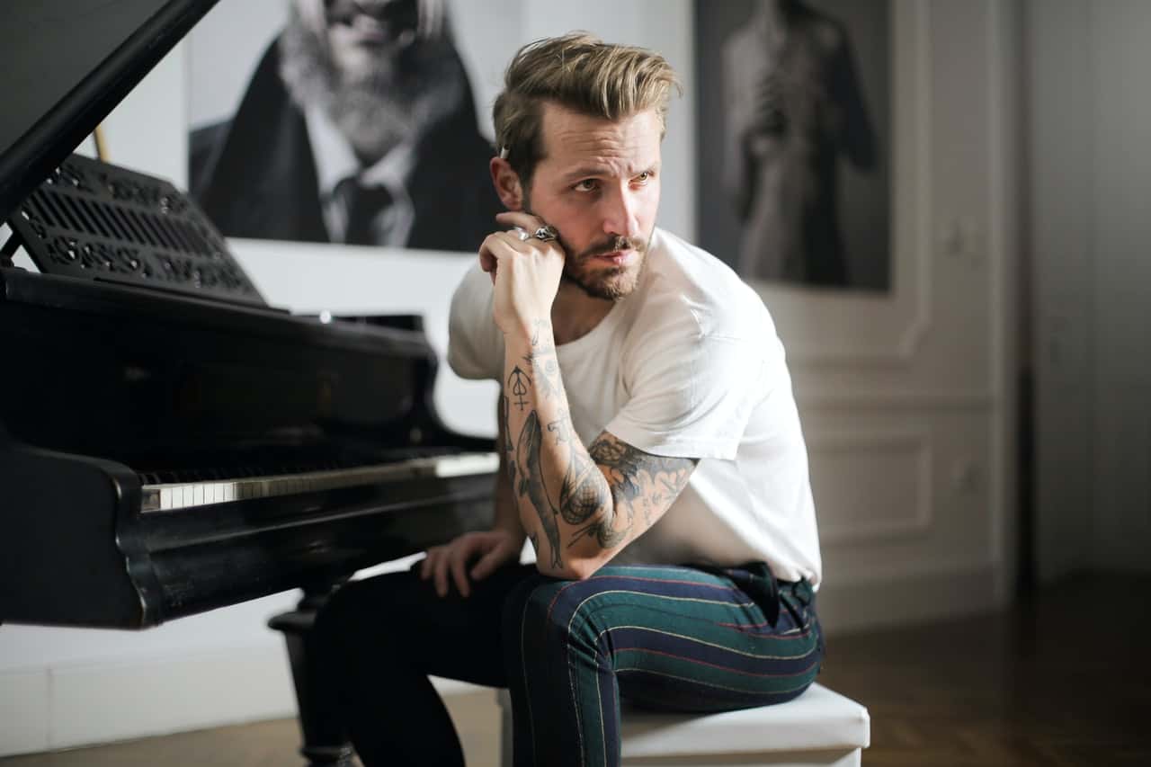 man-in-white-shirt-sitting-beside-piano-3760278