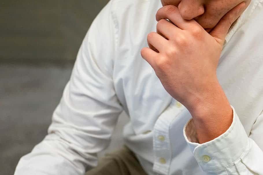 man-thinking-hand-close-up-puzzled-shirt