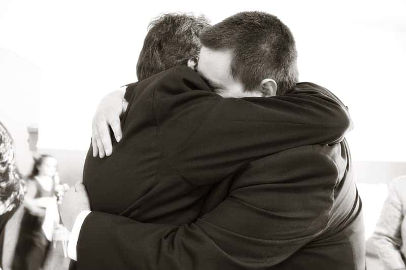 men-wearing-suit-hugging