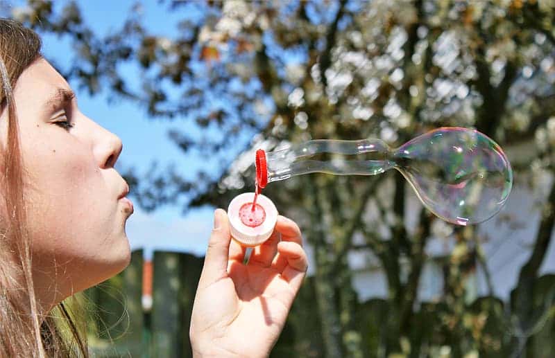 person-holding-pink-bubble-maker