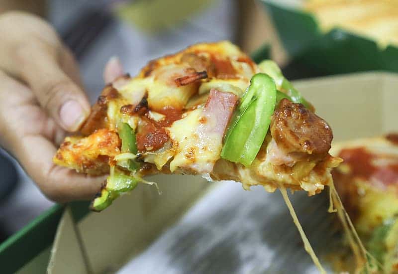 person-holding-sliced-of-pizza