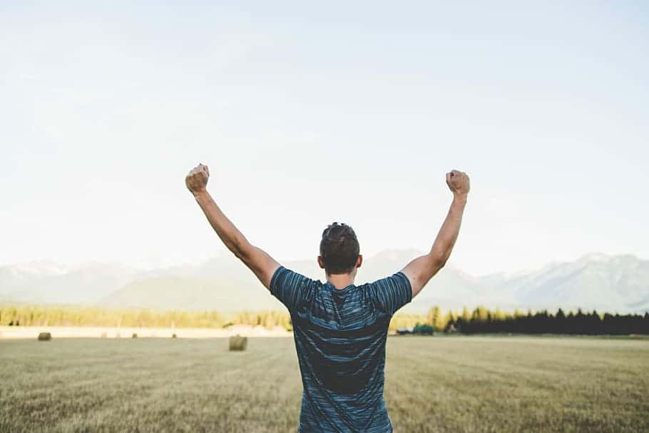 person-raised-arms-fist-victory