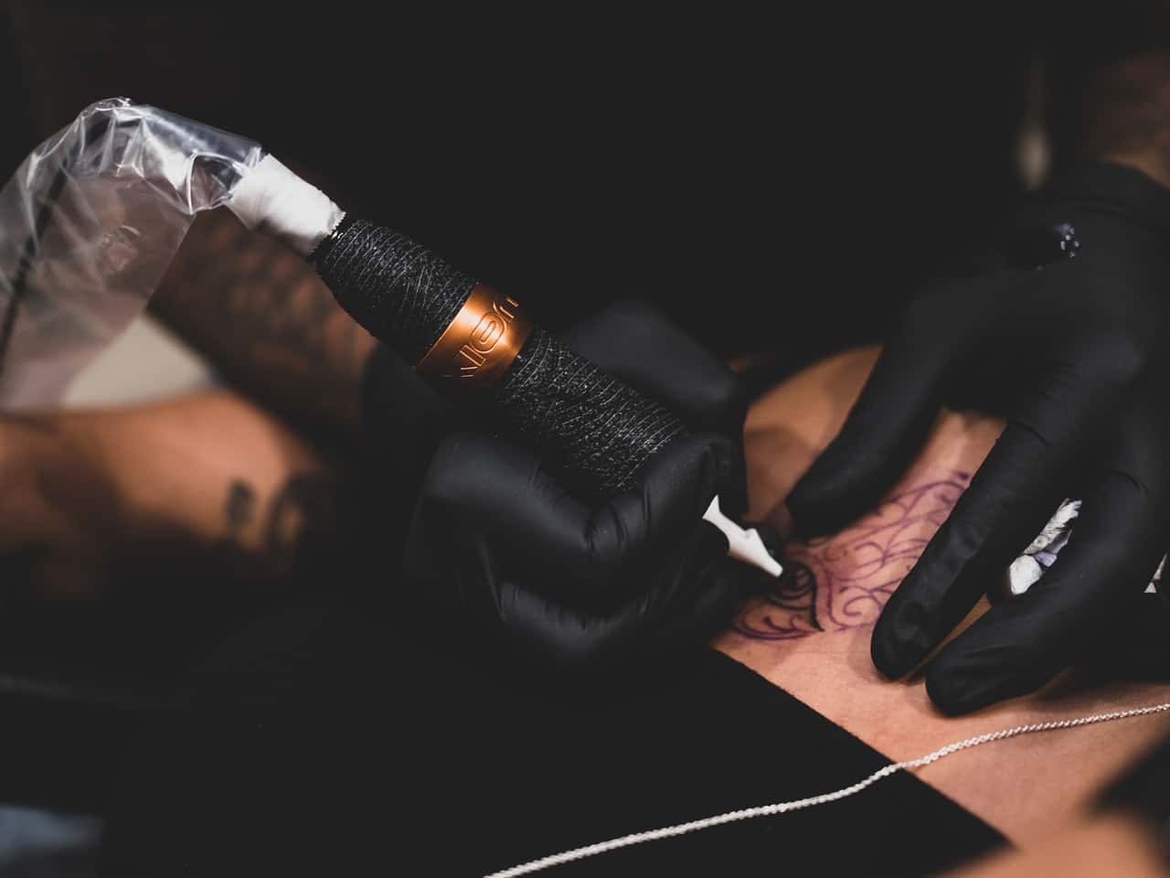 person-tattooing-person-body-2940151