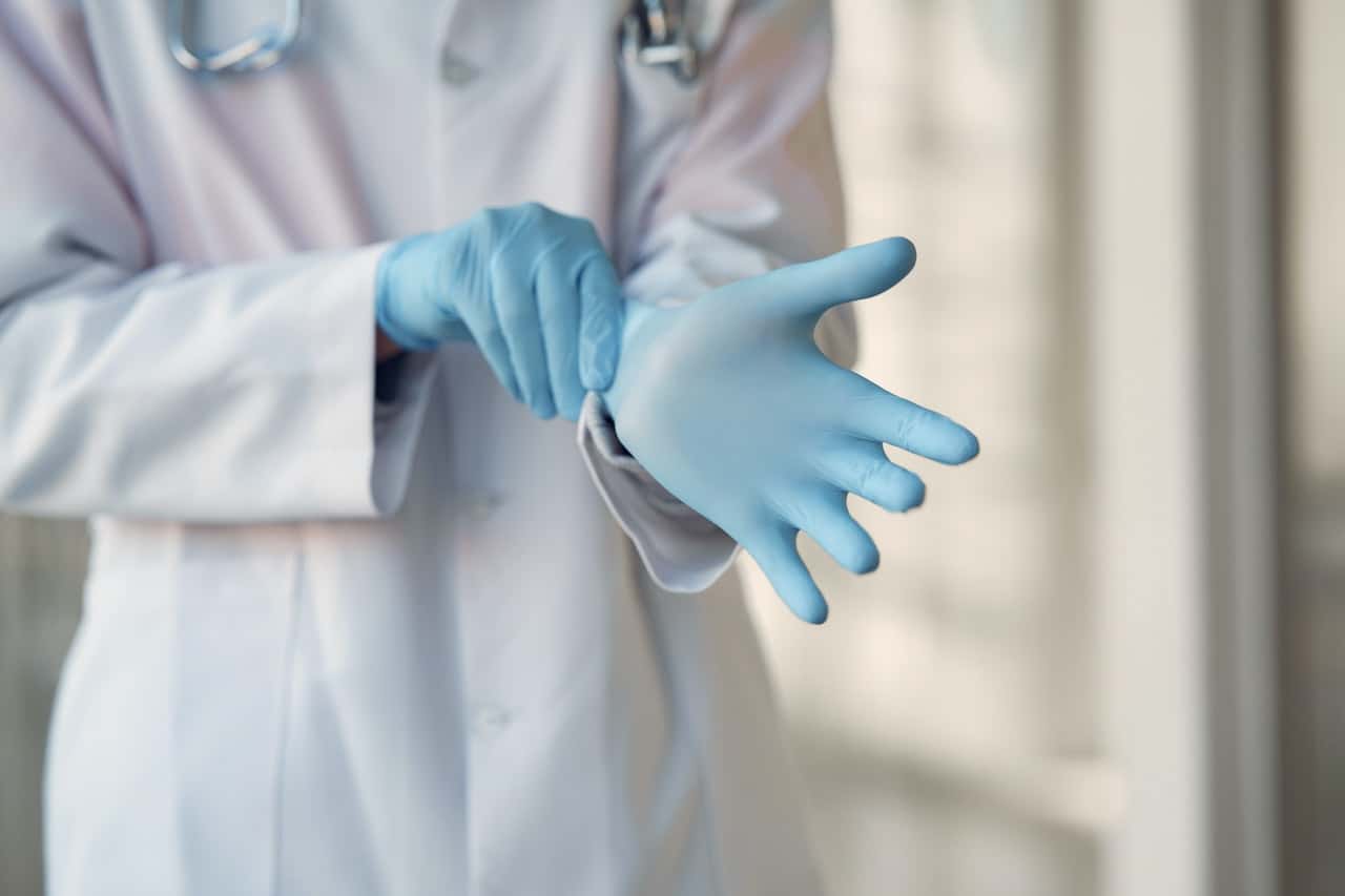 person-wearing-blue-sterile-gloves-3985168