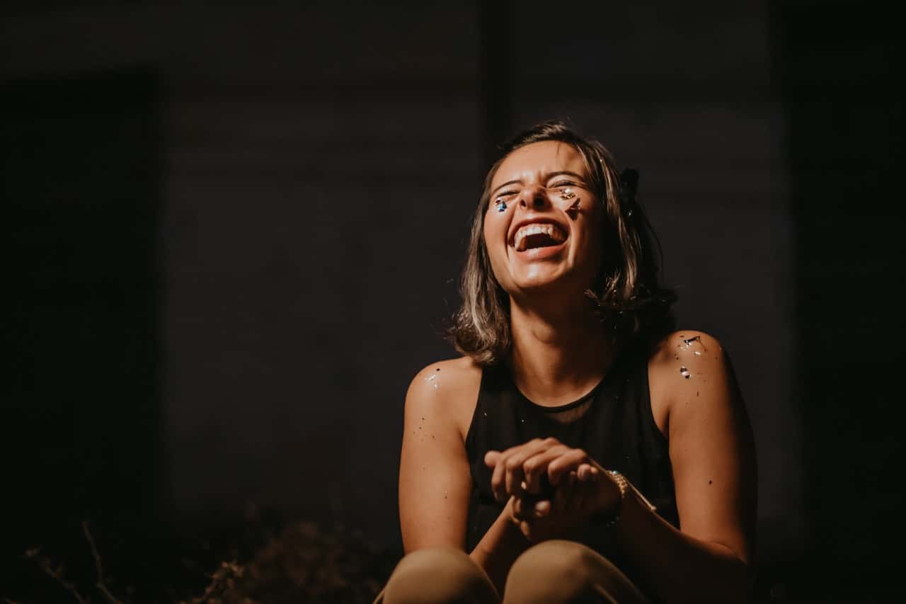 photo-of-a-woman-laughing-wearing-black-top-2219118