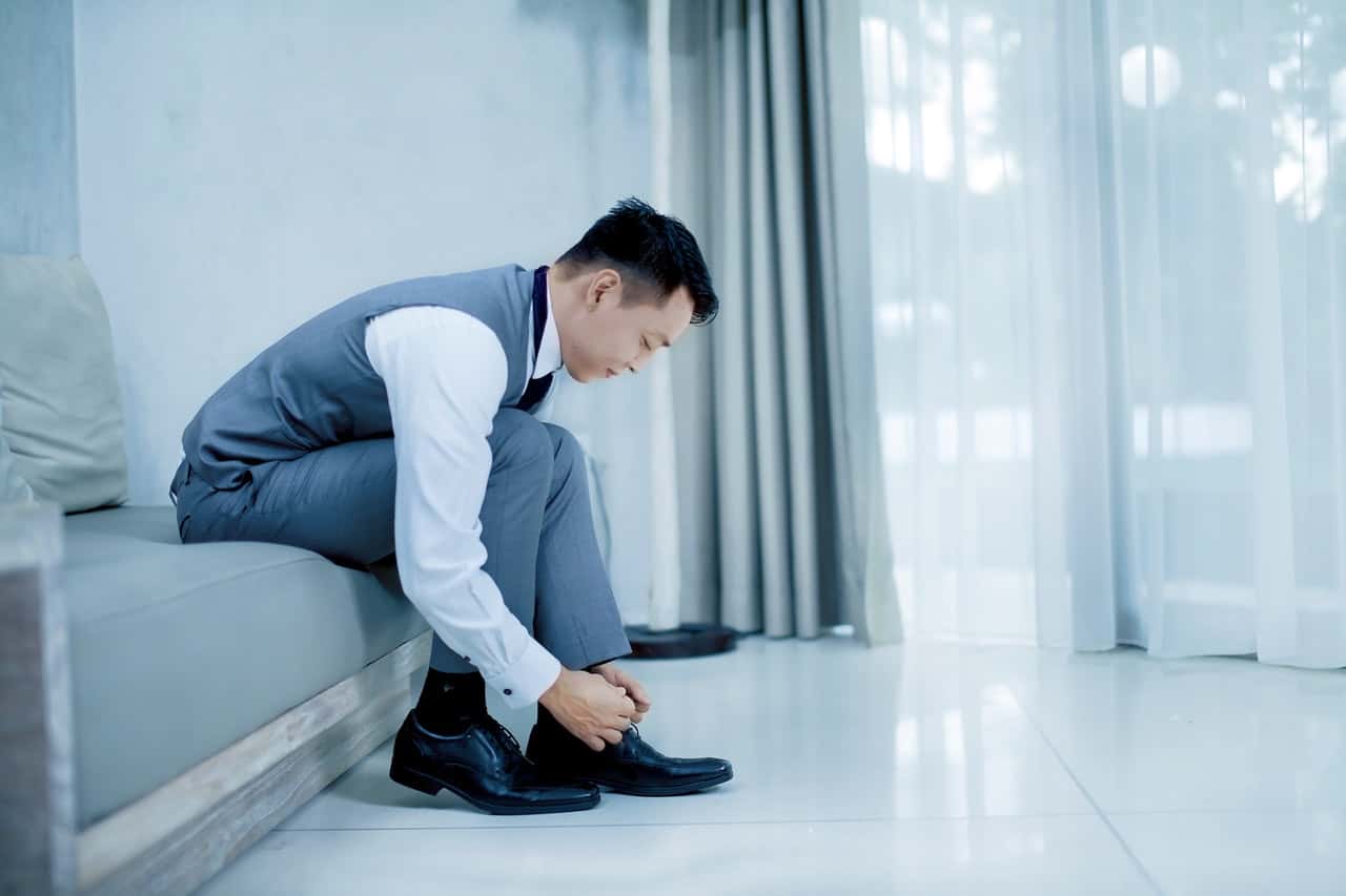 photo-of-man-tying-his-shoes-2269683