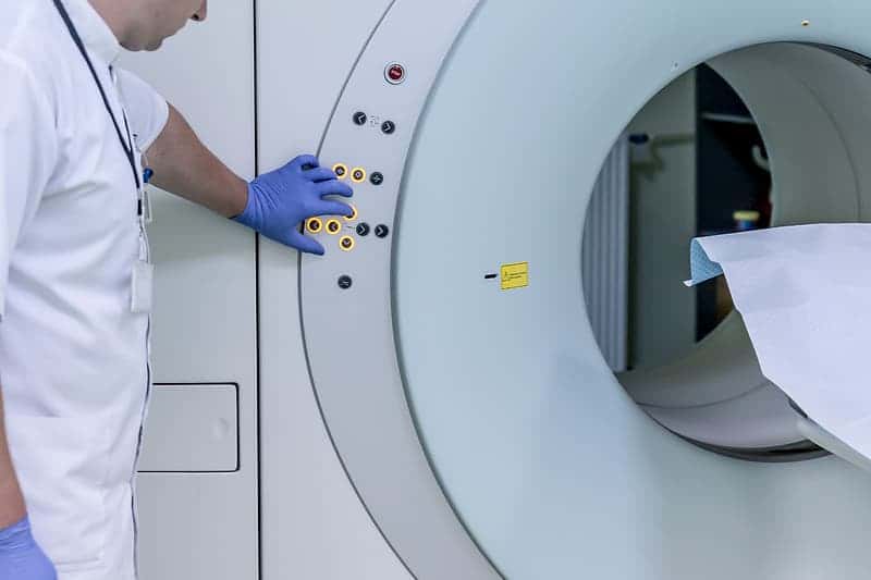 photo-of-person-standing-behind-mri-scan