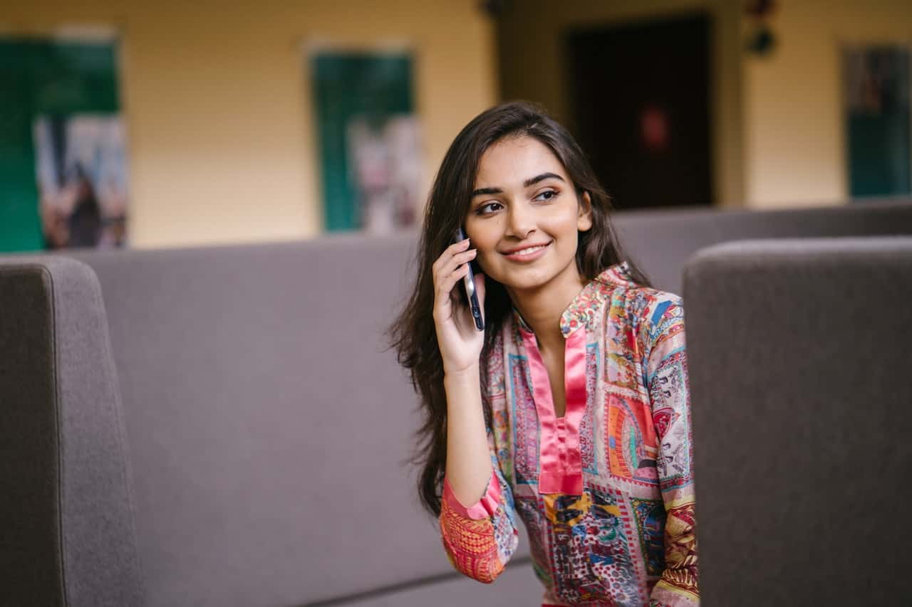 photo-of-smiling-woman-talking-on-phone-2559050