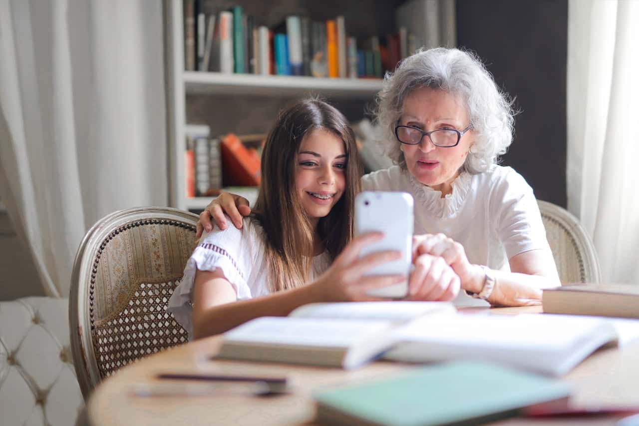 photo-of-woman-showing-her-cellphone-to-her-grandmother-3768140