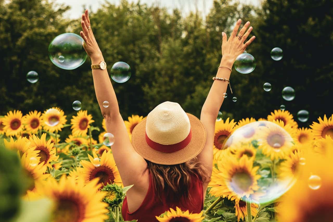 photography-of-woman-surrounded-by-sunflowers-1263986