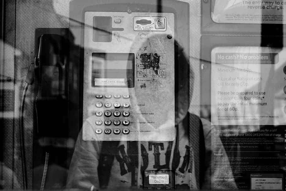 reflection-pay-phone-hoodie-man