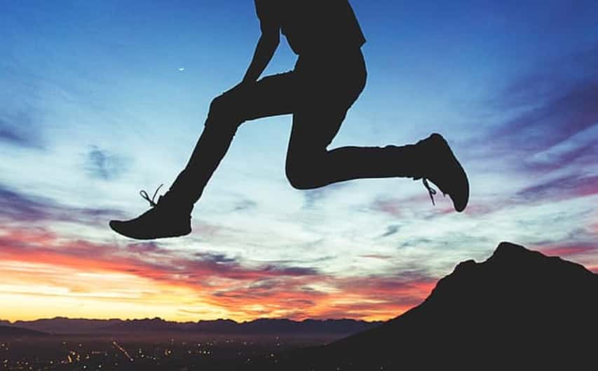 silhouette-of-man-jumping-on-rock-during-sunset