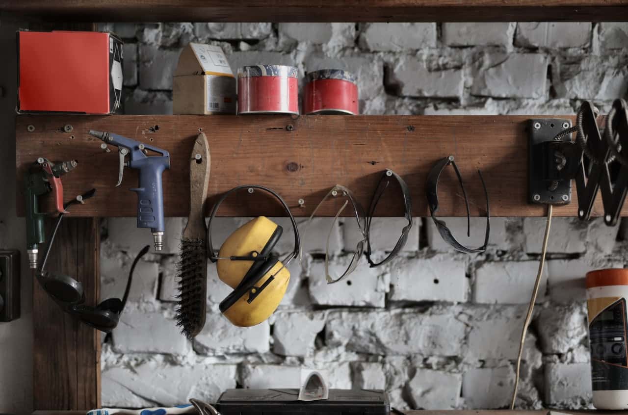 various-instruments-hanging-on-wooden-board-in-garage-3822859