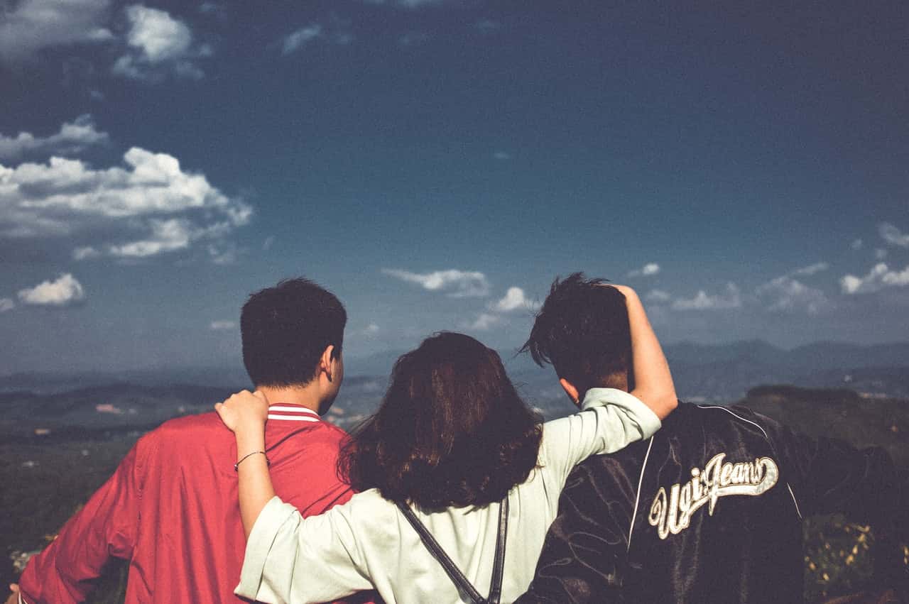 woman-between-men-facing-mountains-1255062