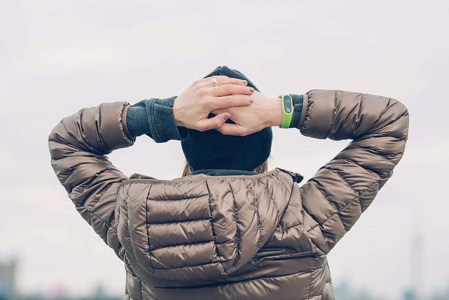 woman-hands-head-smart-watch-jacket