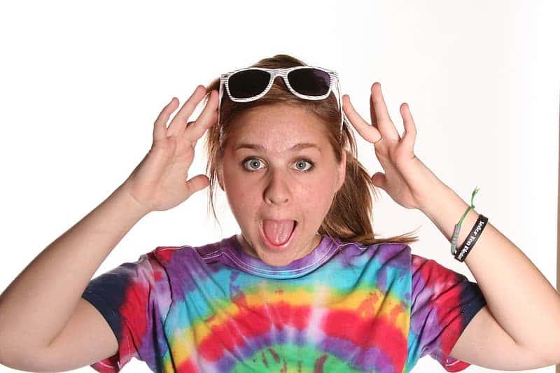 woman-holding-sunglasses-on-head-with-tongue-out