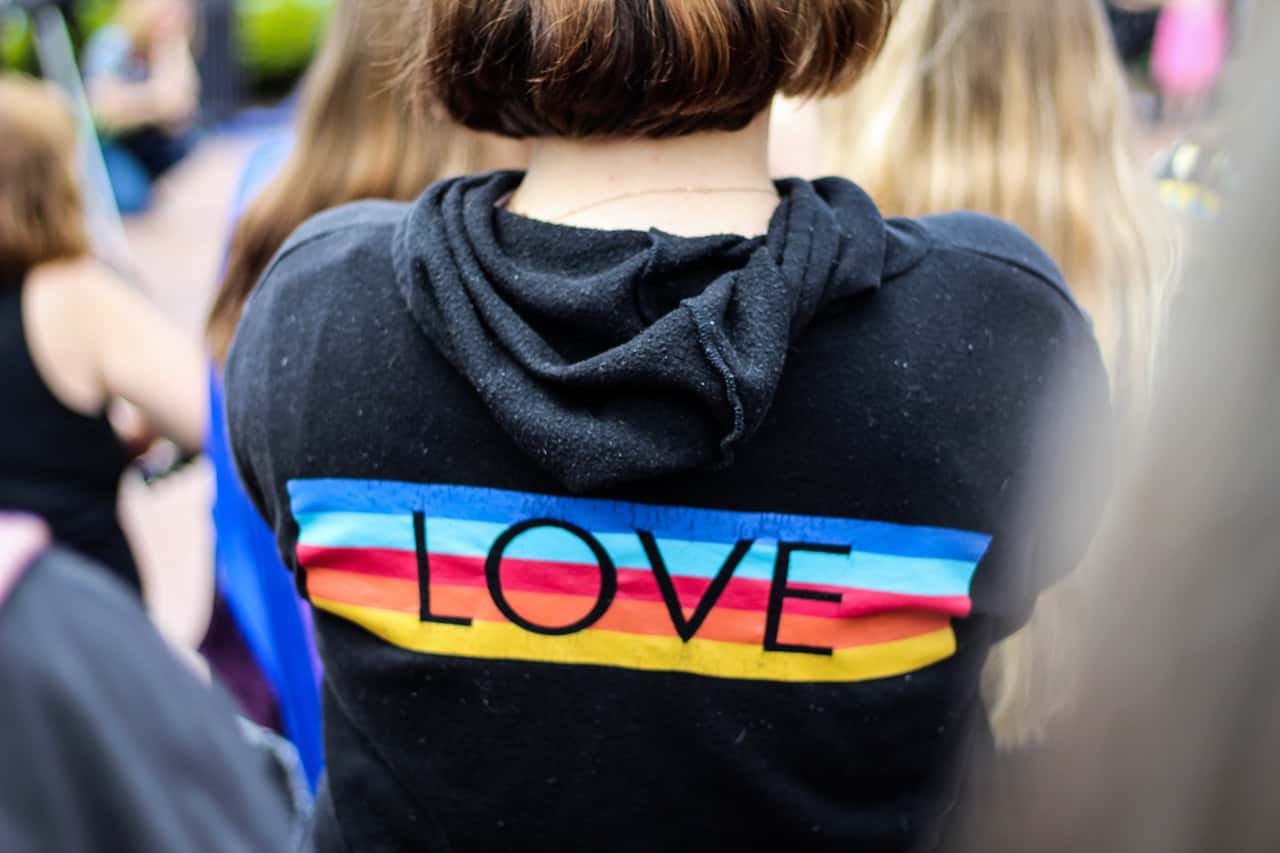 woman-in-black-and-multicolored-love-print-hoodie-2306823