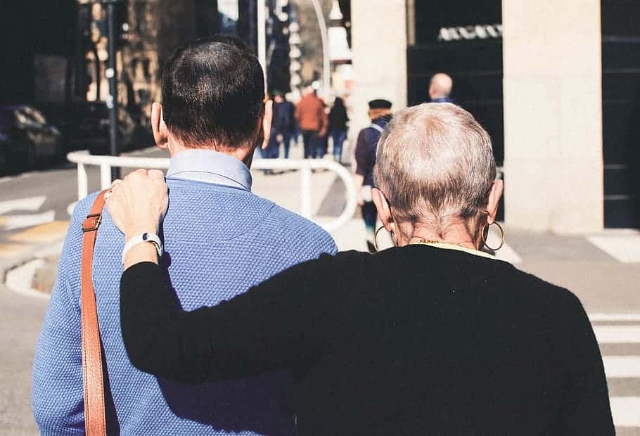 woman-put-her-hand-on-man-s-shoulder-while-walking-during-daytime