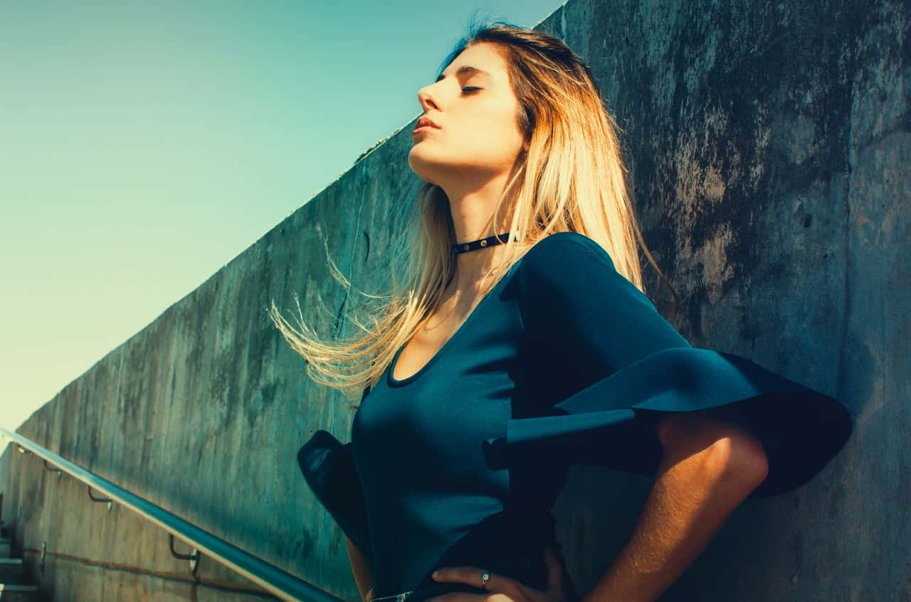 woman-wearing-blue-scoop-neck-top-standing-near-gray-821413