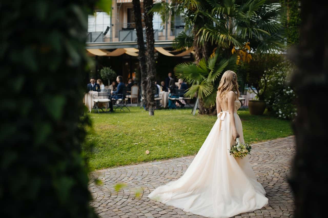 woman-wearing-wedding-dress-and-holding-a-bouquet-of-flowers-2472858