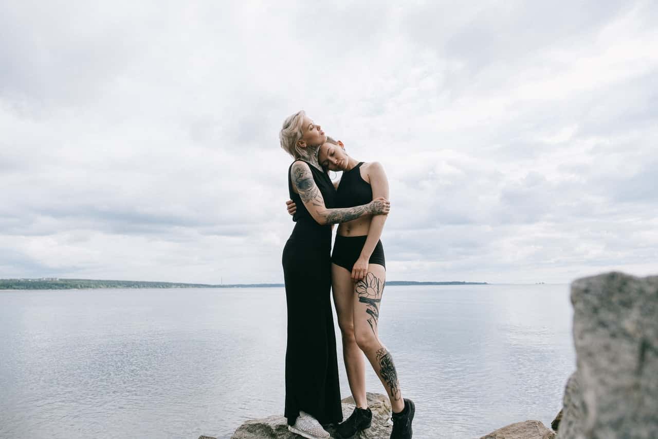 women-hugging-on-beach-3727657