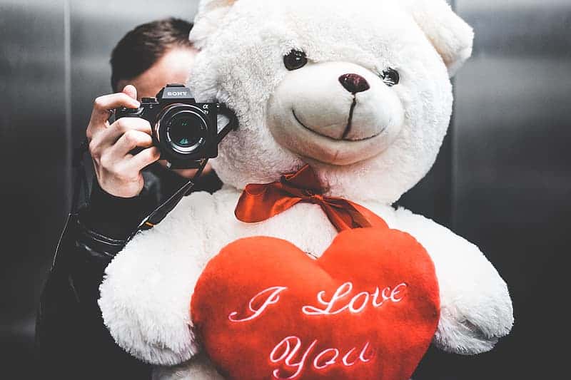 young-man-taking-selfie-with-big-teddy-bear-for-his-girlfriend-in-elevator