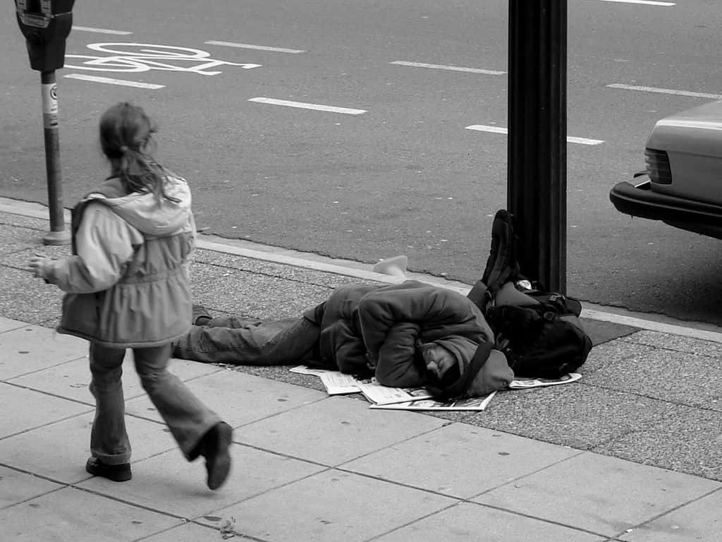 1024px-Man_sleeping_on_Canadian_sidewalk